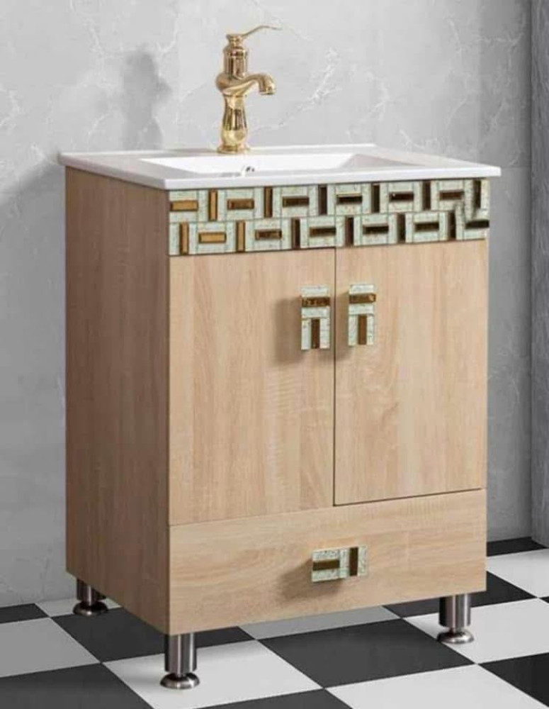 Freestanding bathroom vanity Cabinet with a light wood finish and a decorative moasiac-style trim
