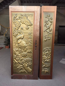 Ornate Security Door with detailed carvings and a brass finish