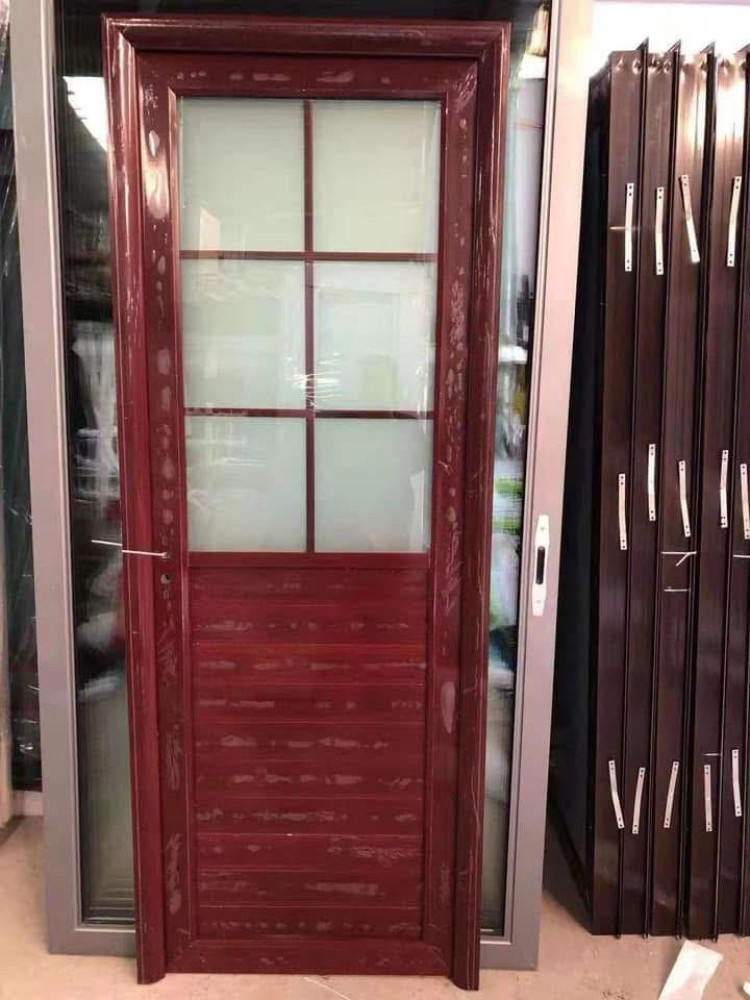 Aluminum door with a wood-grain finish and frosted glass panel