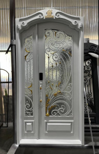 White wrought iron and glass security door with gold accents