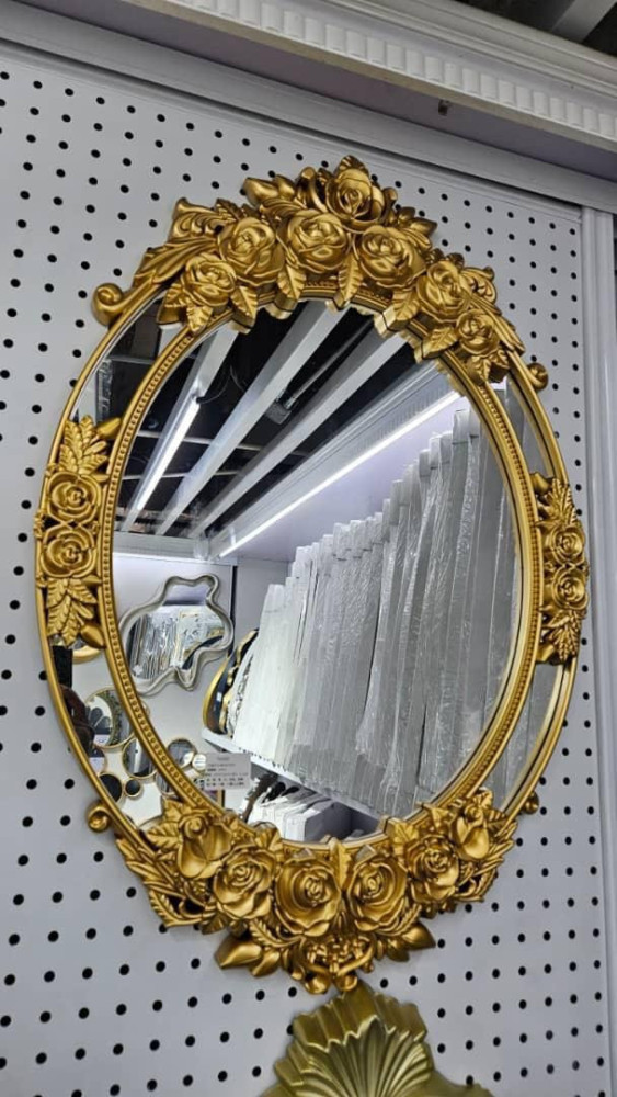 Decorative Oval wall Mirror with a Gold-coloured, ornate, floral-patterned frame