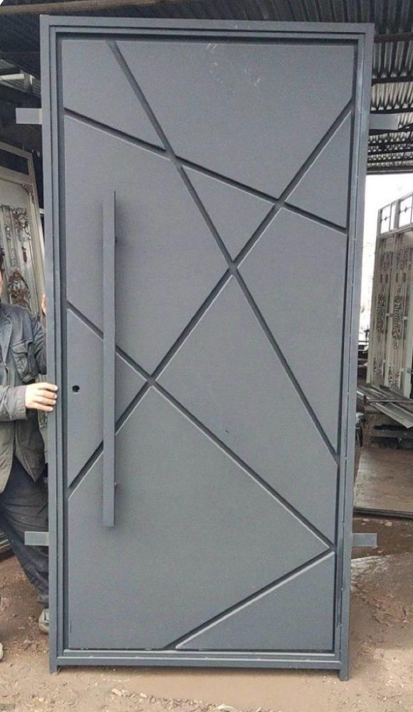 Modern Steel and Iron Pivot door with an abstract geometric design