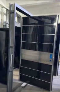 Modern Pivot Door with sleek black finish and a horizontal stainless Steel accent Panel