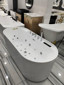 White jetted bathtub with a fluted exterior