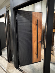 Modern Security Entrance Door with black textured metal panel and a wood-look veneer panel